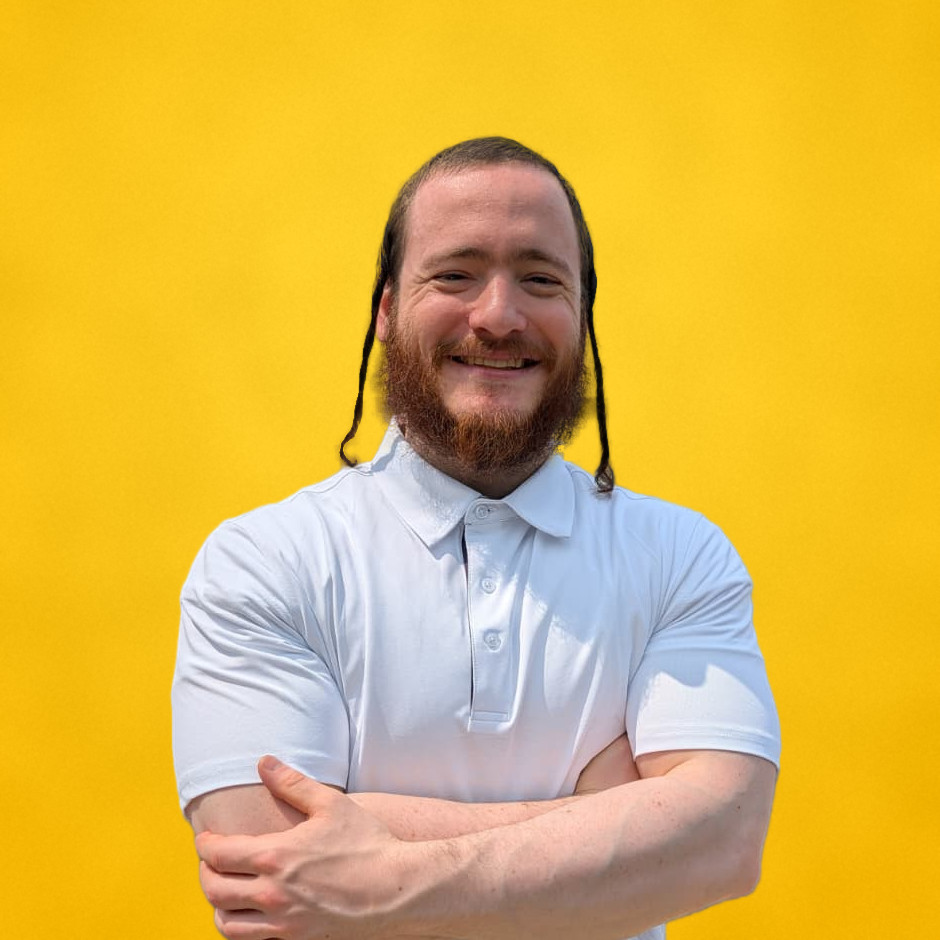 Shmuel, smiling with arms crossed